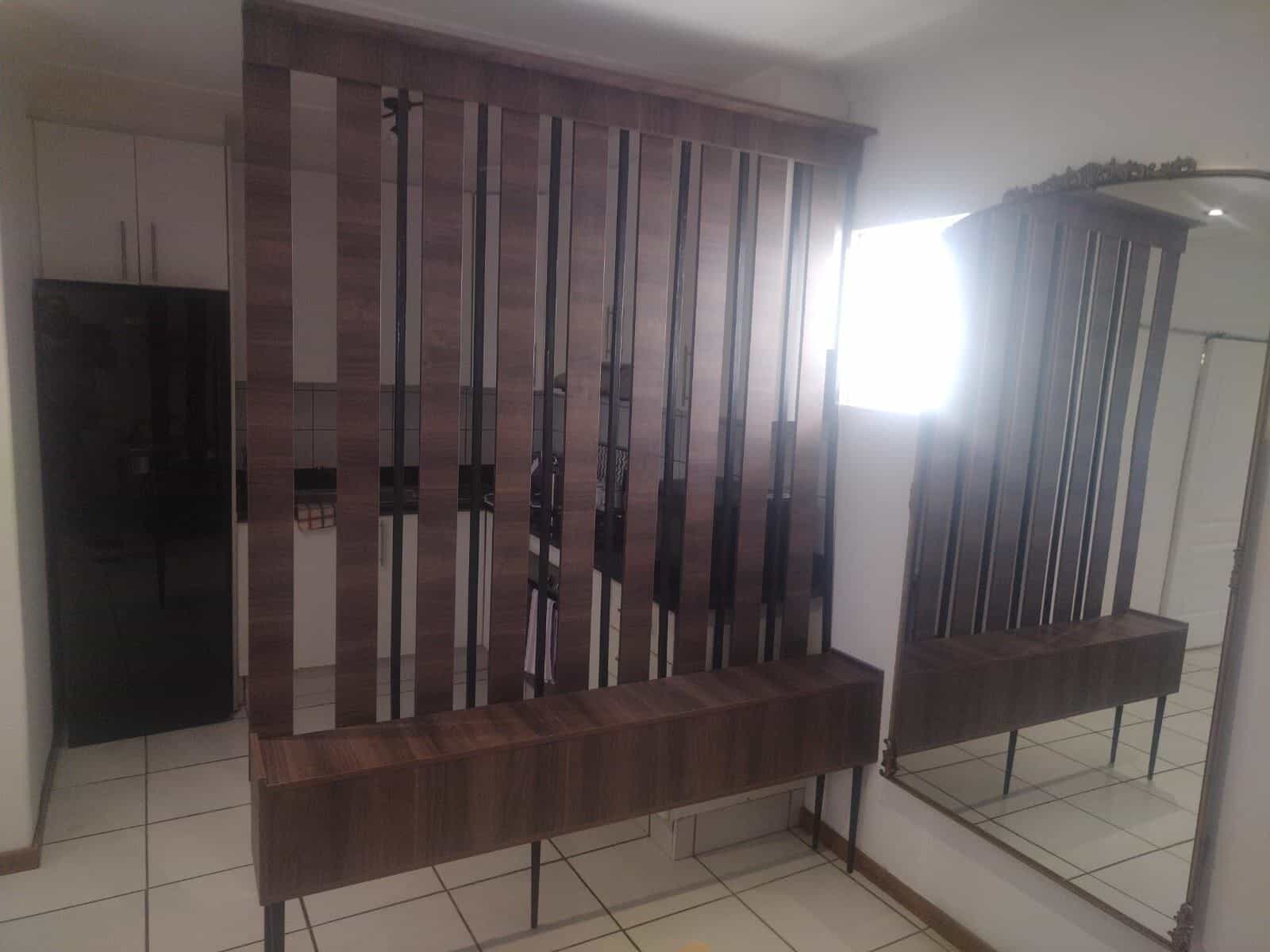 Custom wood room divider with mirror panel, made to the client's spec
