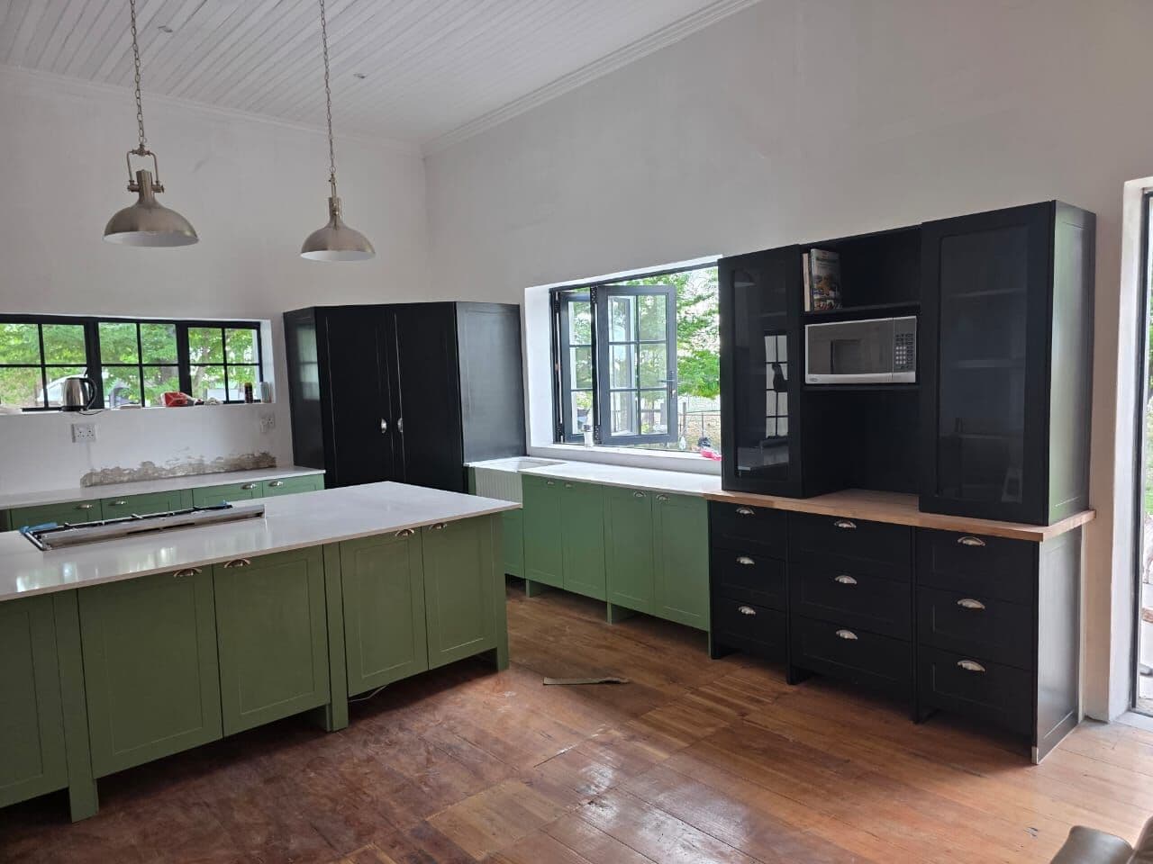Kitchen island and black tall units made and fitted by Elite Home Finishes