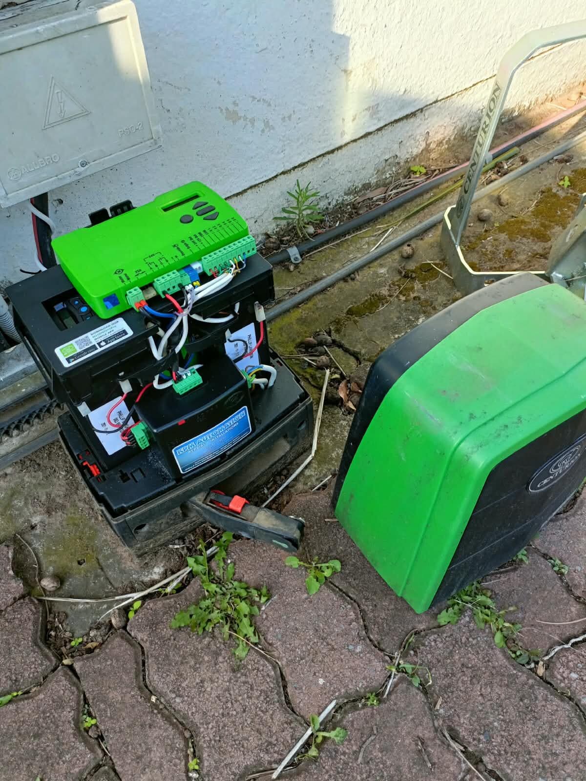 Gate motor controller and battery fitted beside the motor housing after a gate motor repair