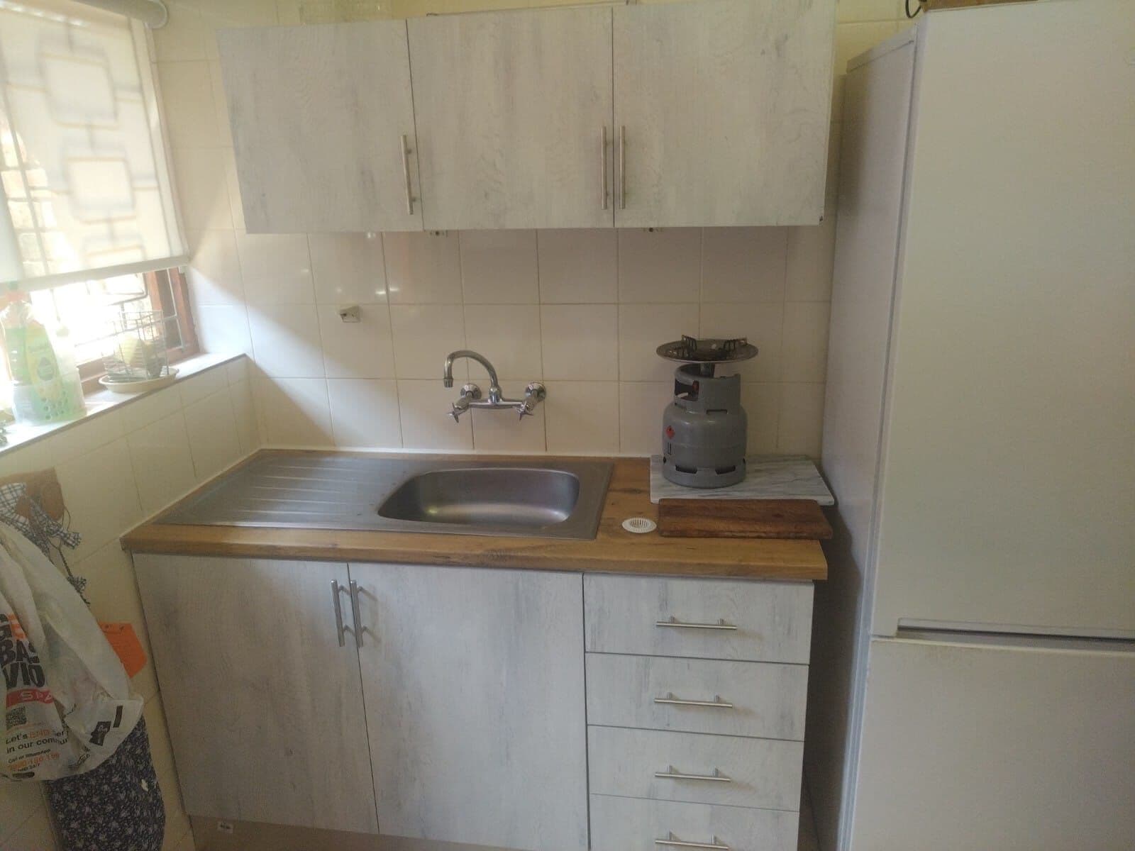 Sink unit with drawers and matching wall cupboards above