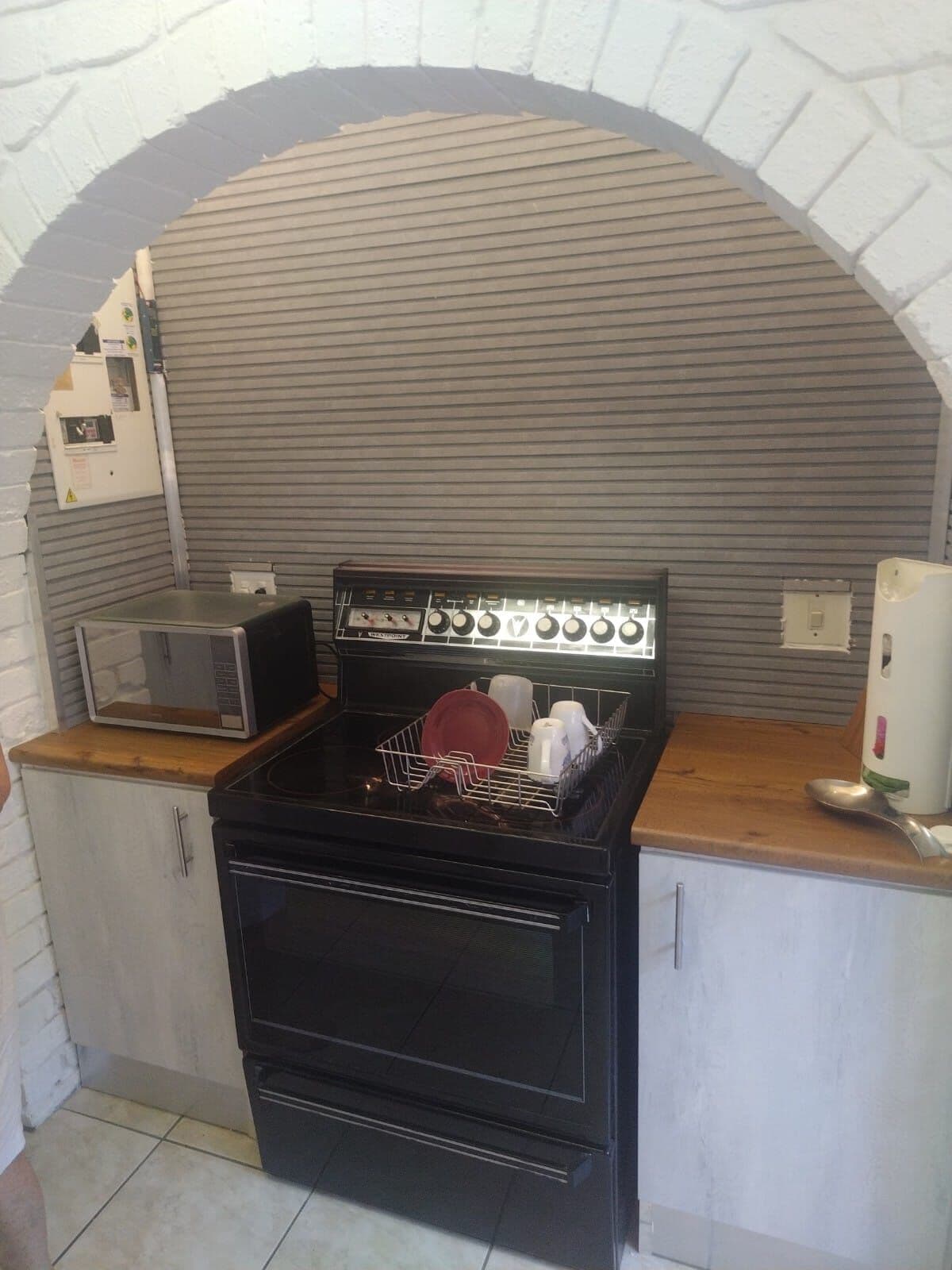 Base cupboards with timber tops fitted either side of a stove alcove