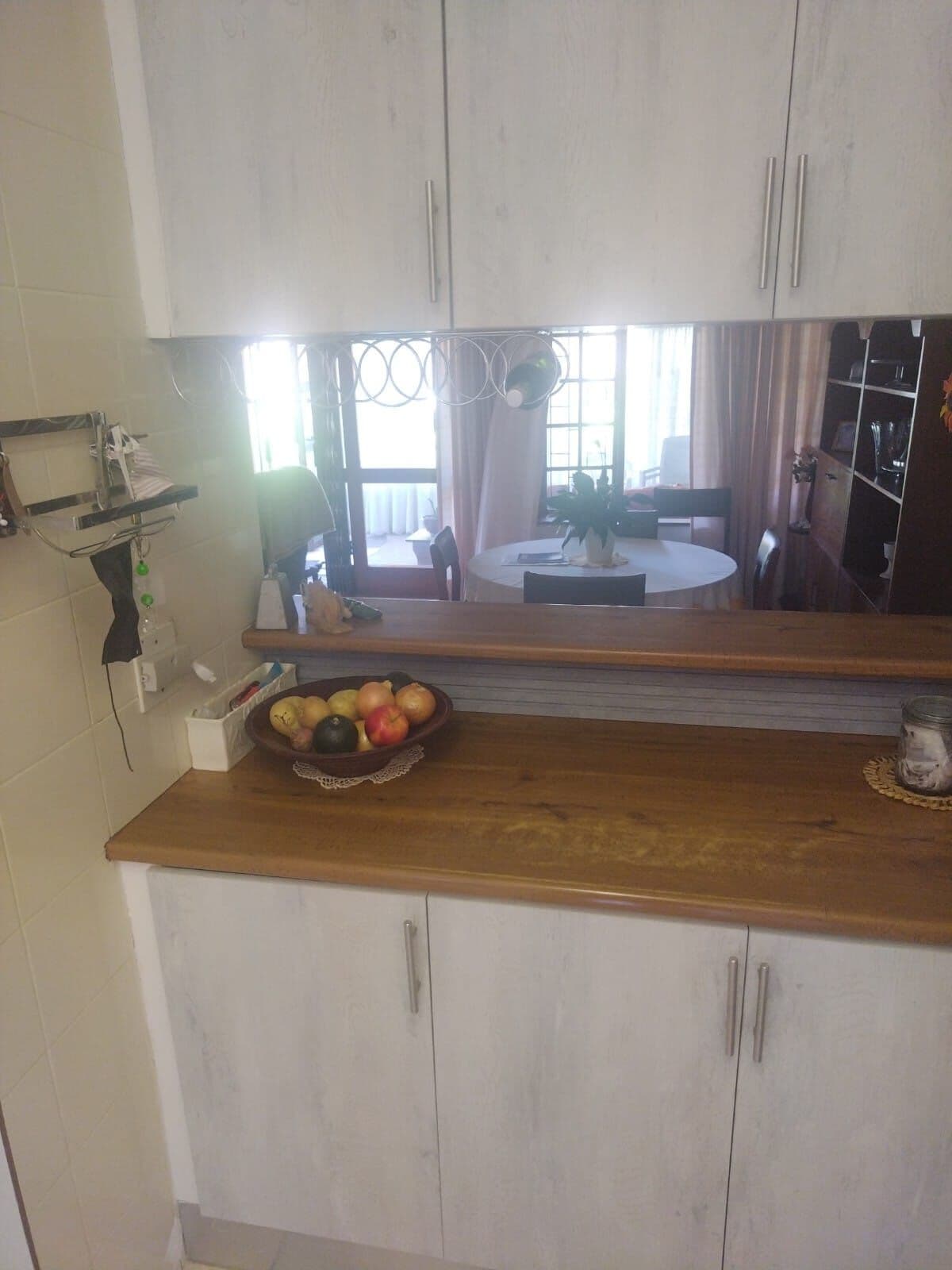 Whitewash wall and base cupboards with a timber breakfast counter