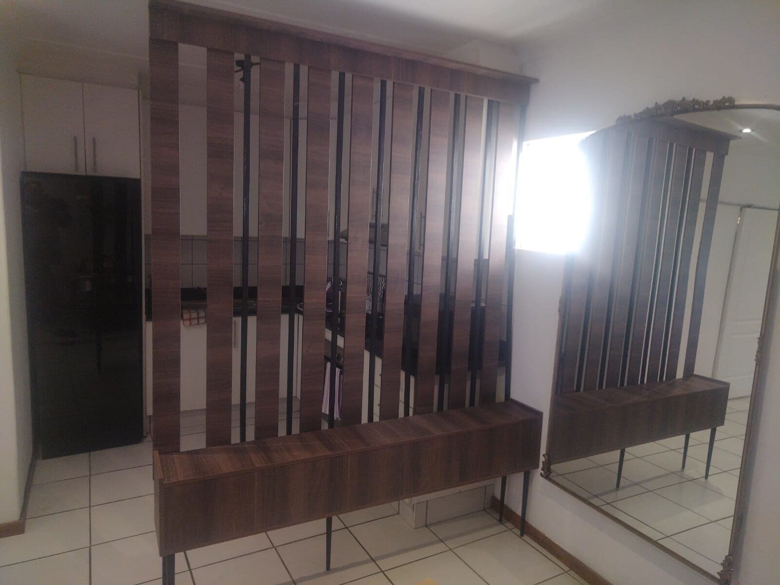 Custom wood room divider with mirror panel, made to the client's spec