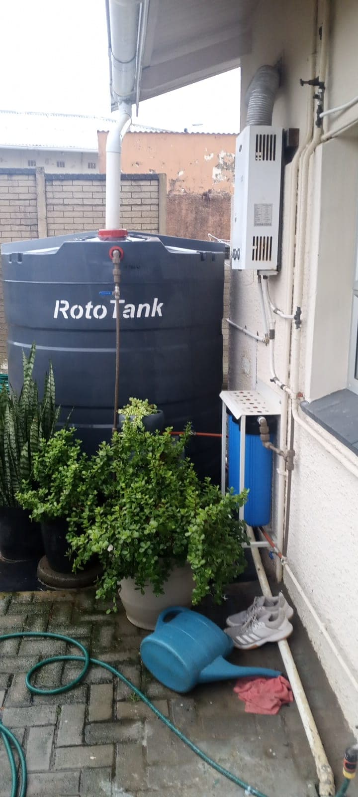 Filtration system installed beside a RotoTank rainwater tank