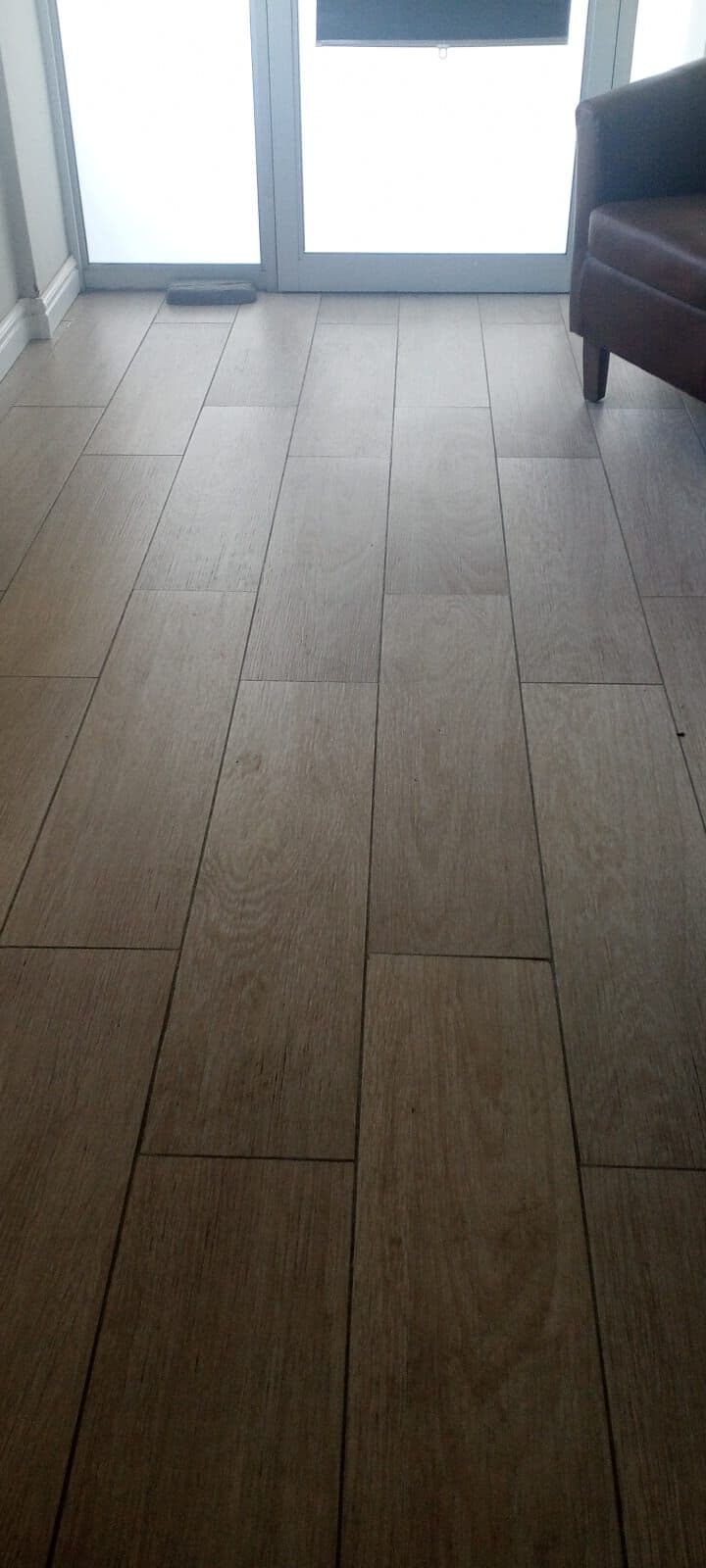 Wood-look plank floor tiles laid by Elite Home Finishes