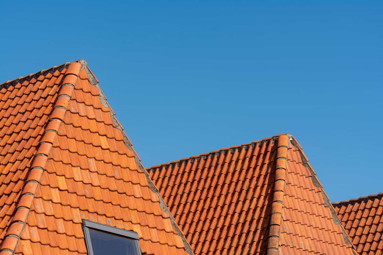 Terracotta roof tiles against a clear blue sky